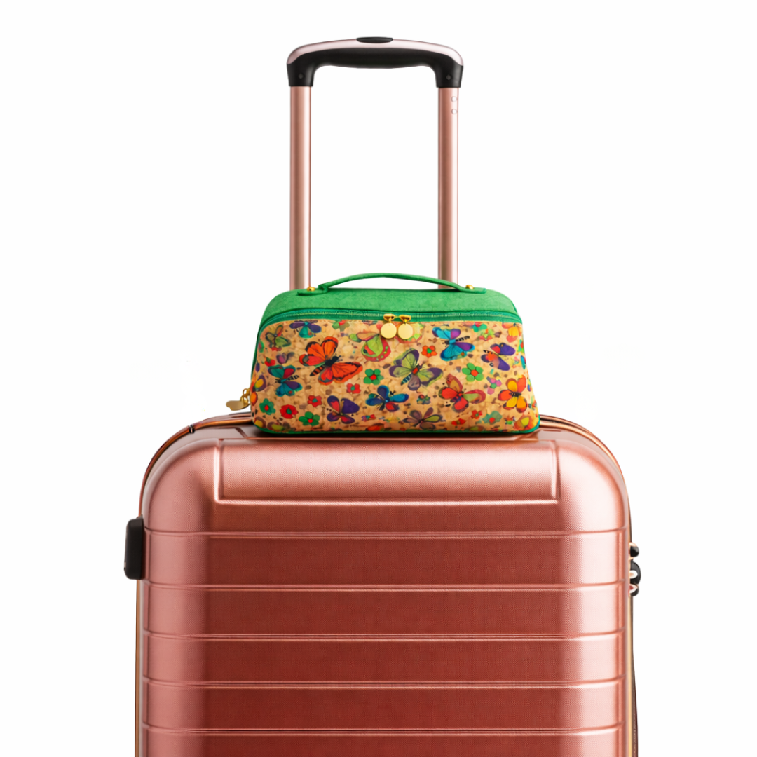 Rose gold suitcase with Mar cork leather butterfly-patterned bag on top 
